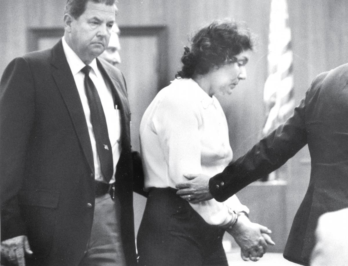 "The Black Widow," Judias Buenoano, is handcuffed and led by a United States Marshal.