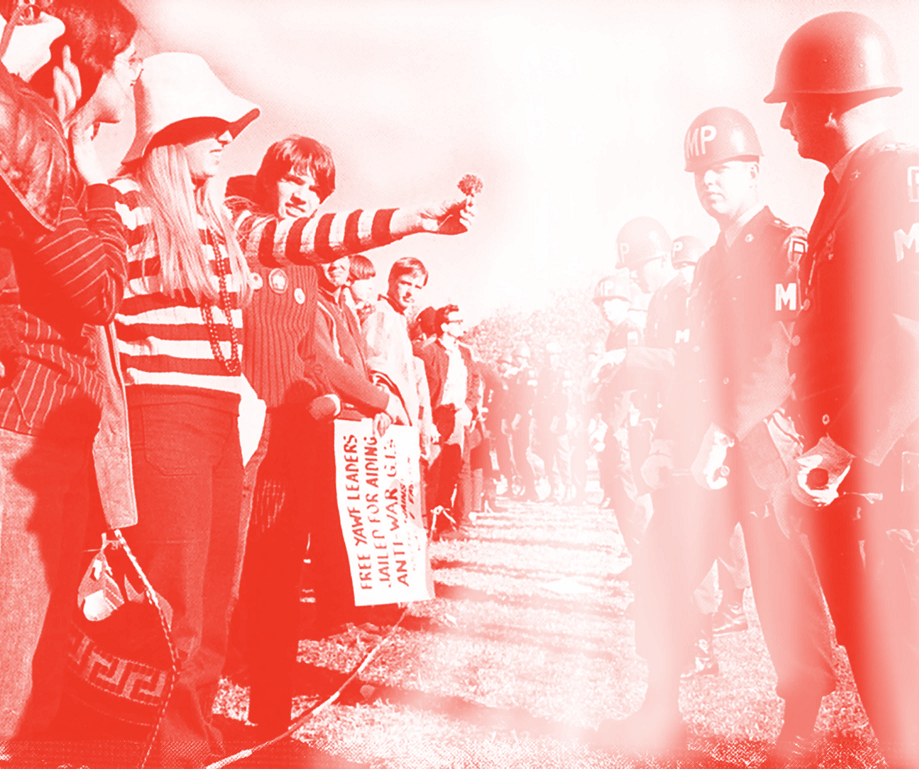 A young conscientious objector offers a flower to a military police officer at a peaceful demonstration against being drafted for the Vietnam War.