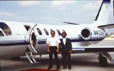 Mazur and an undercover customs pilot standing in front of a private jet used in the operation