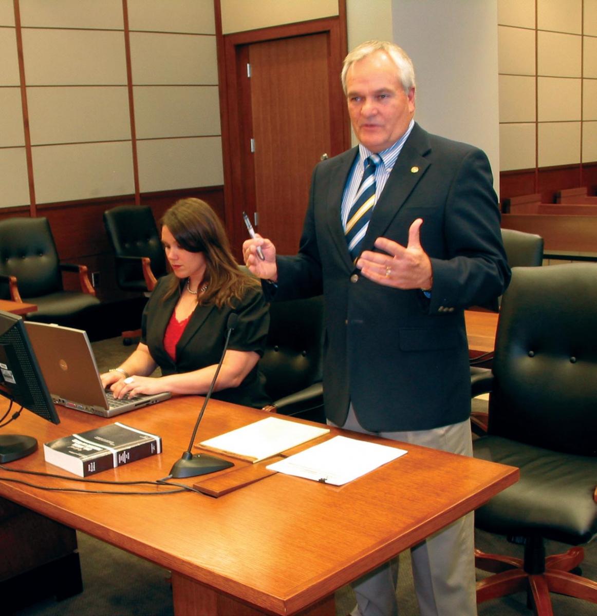 A lawyer presents evidence in court on behalf of his client.