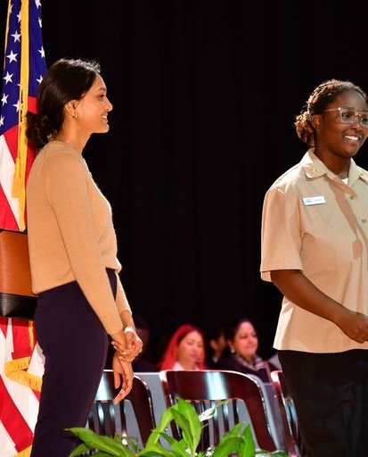 A member of the Naval JROTC introduces a new citizen.