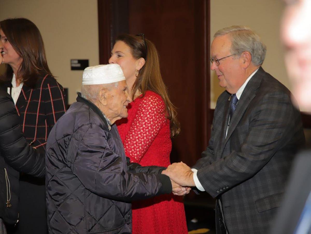 Mr. Cofer congratulating the oldest new citizen. Mr. Cofer congratulating the oldest new citizen.